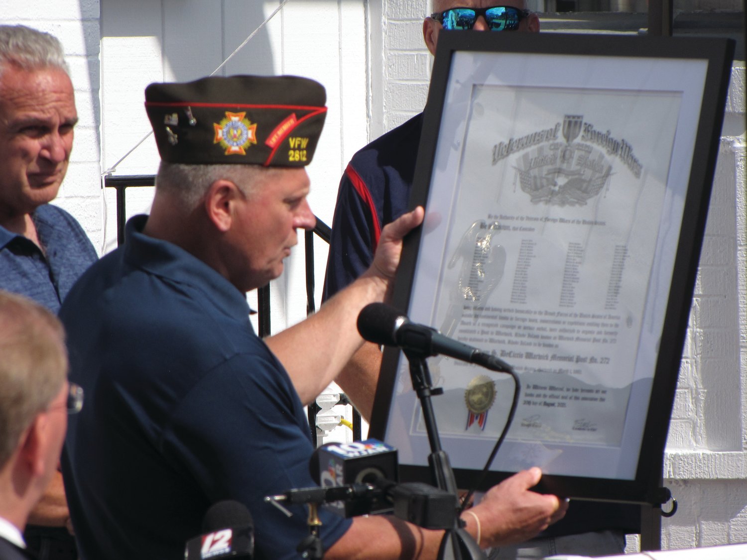NEW CHARTER:  Raymond Denisewich of the VFW holds the new charter for Post 272, which was rededicated in Adam DeCiccio’s honor.